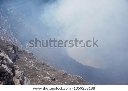 Active Volcano with sulfuric smoke. Looking down the crater of a volcano. close up view at the mouth of a volcano