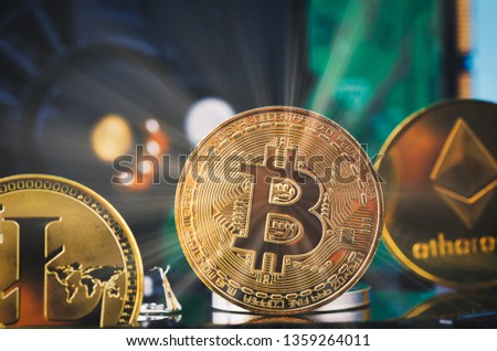Virtual Cryptocurrency and Blockchain Technology concept, golden bitcoin on dismantle hard disk over gently lit dark background and light ray