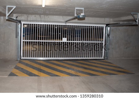 Underground cement car park garage parking entry door gate empty without cars