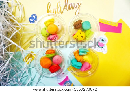 sweet heart, baby bear, circle, sea lion macaron, blue, yellow, orange, pink macarons with sloth cartoon and watermelon, macarons on yellow and blue background
