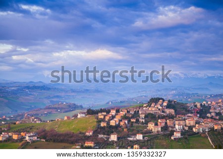 Italian countryside. Rural landscape. Province of Fermo, Italy. Village on hills under cloudy sky
