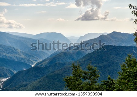 The gorge among the mountains with green slopes. Krasnaya Polyana, Sochi, Russia