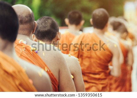 Group of Monks bath Buddha sculputer purify body and spirit in Songkran festival, Thailand