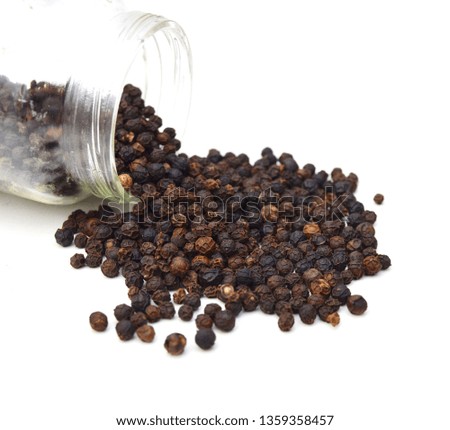 Black peppercorns in jar, isolated on white background 