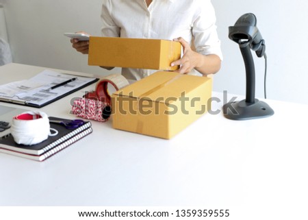 Small business Worker  delivery service and working packing box, business owner working checking order to confirm before sending customer in post office, Shipment Online Sales
