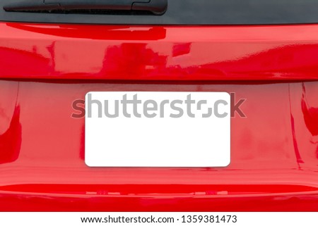 Horizontal shot of a blank white license plate on a red car with copy space.