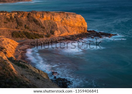 Long exposure photo of Inspiration Point cliff at sunset with waves crashing onto the rocks below Abalone Cove Shoreline Park, Rancho Palos Verdes, California