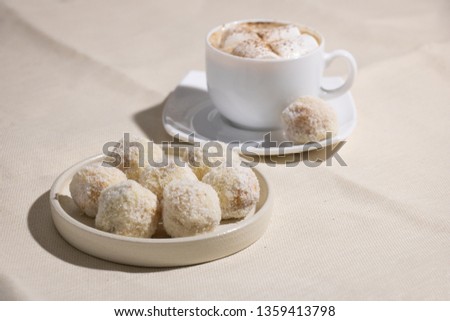 Tasty Sweets Covered with Coconut Chips. Handmade Candies and Cup of Coffee with Marshmallow on Dark Background. Tasty Luxury Dessert