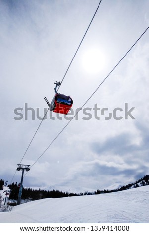 ski resort Goderdzi, Georgia. mountains are covered with snow. Red cable car above and mountains behind  - Image
