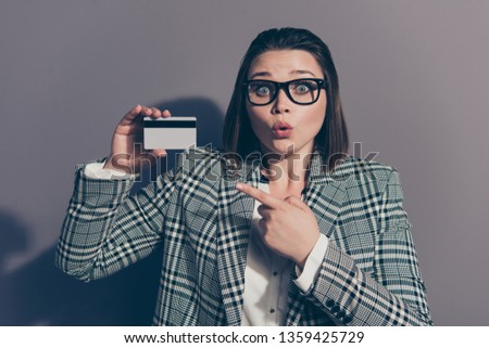 Closeup photo portrait of amazed she her lady holding showing plastic card in hands wearing checkered plaid with collar suit blazer jacket isolated grey background