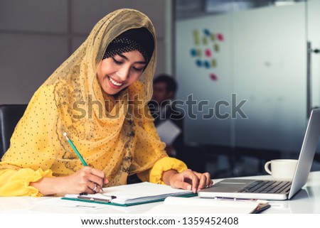 Successful Middle Eastern Muslim businesswoman working in office. International business success concept.