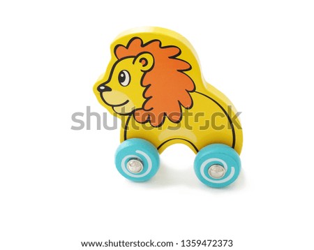 Children's wooden toy lion on wheels. isolate on white background.


