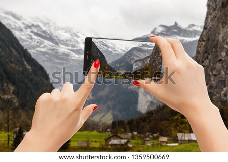 Switzerland - Beautiful medieval town on a phone, woman taking a picture of the skyline