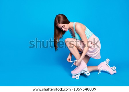 Full length side profile body size photo beautiful floor she her lady hands tied fixing retro rollers laces together fit ideal body wear casual street summer dress clothes isolated blue background
