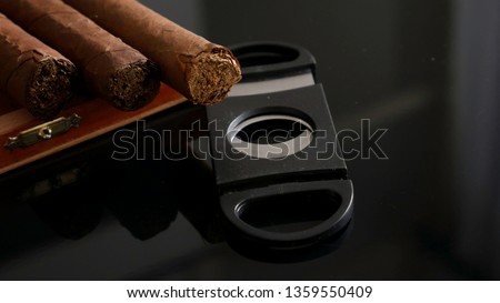 Quality cigars and cigar cutters Royalty-Free Stock Photo #1359550409
