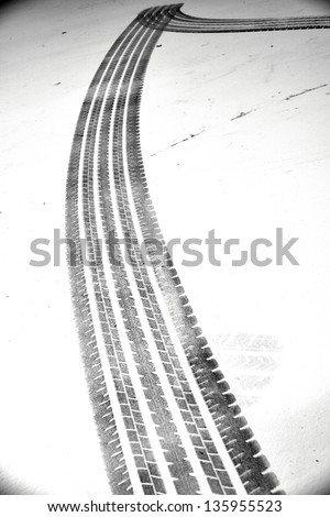 Grunge black tire track on white background