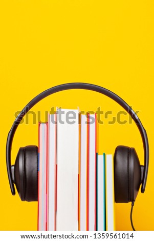 Group of books with the earphones. Audiobooks. Listen and study concept.