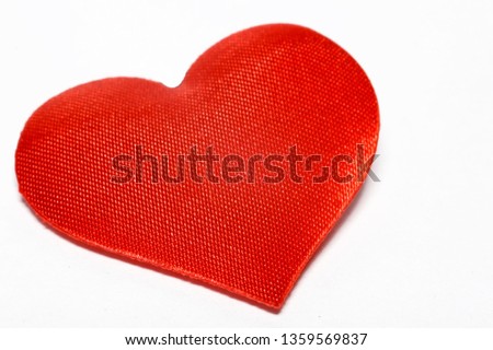 Red heart made of cloth on a white background. Feelings, love, passion concept.