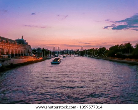 Sunset at the Seine river in the downtown area of Paris, France. Beautiful cityscape of Paris in France at sunset with dramatic sky.