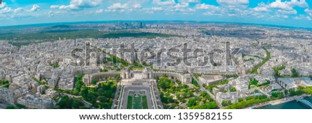 Panoramic aerial view of Paris, France with Trocadéro Gardens Palais de Chaillot and La Defense from Eiffel Tower on a sunny day. Beautiful wide view of the capital of France, Paris with a cloudy sky.