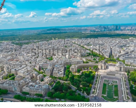 Panoramic aerial view of Paris, France with Trocadéro Gardens Palais de Chaillot and La Defense from Eiffel Tower on a sunny day. Beautiful wide view of the capital of France, Paris with a cloudy sky.