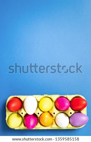 Easter eggs in a paper bag on trendy blue background. 2019. Easter card. Space for text. Happy easter.