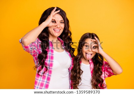 Portrait of nice attractive cheerful positive crazy foolish wavy-haired girls wearing checked shirt showing ok-sign like glasses isolated over bright vivid shine yellow background