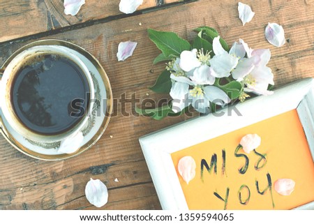 coffee and picture frame on a wooden table