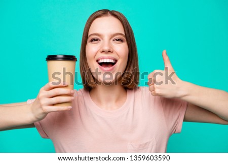 Close up photo beautiful amazing her she lady thumb up hold arm paper hot coffee take away made advising favorite americano latte cappuccino wear casual t-shirt isolated teal turquoise background