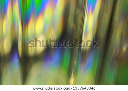 Light split into colours by a glass surface. Close up of glass with light interference effect, color diffraction. Transparent optical element that refract light.