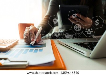 Business woman documents on office table with smart phone and digital tablet and graph financial, Social network icon.