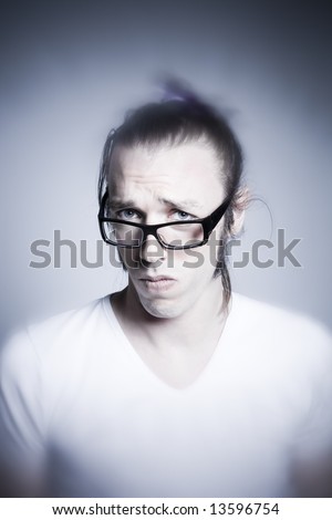 studio shot portrait of young expressive man making faces