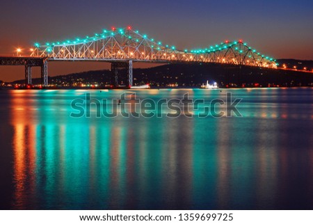 The lights of the former Tappan Zee Bridge reflect in the Hudson River