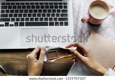 Eating an office snack, chocolate time! Royalty-Free Stock Photo #1359707207