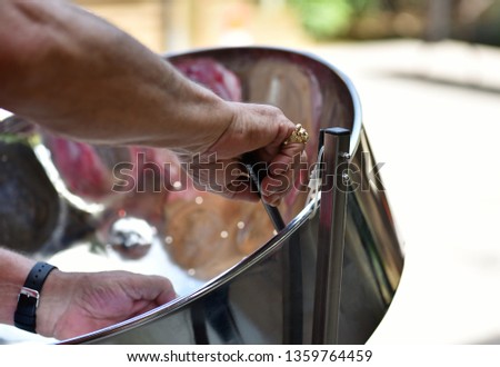 Caribbean Steel pan drum player with sticks Royalty-Free Stock Photo #1359764459
