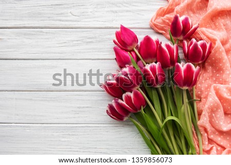 Pink spring tulips on a white wooden background