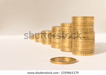 Stacks of coins on a light background. Business concept and growth of capital