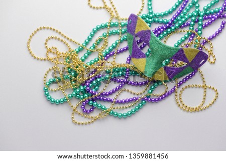 Festive mask with beads on light background