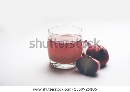 Medicinal Onion juice/syrup in a glass with raw onions. selective focus