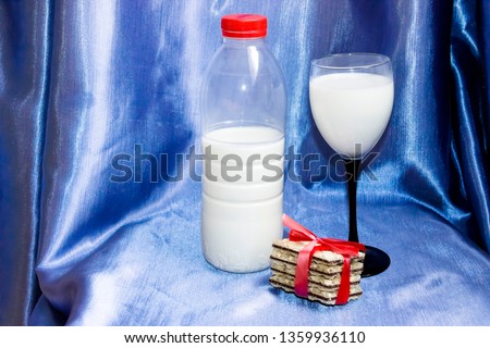 pictured in the photo bottle of milk with blue background and biscuit