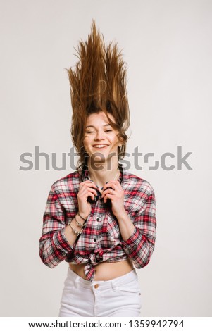 Happy young caucasian woman wearing shirt and shorts with headphones smiling and posing on the white background