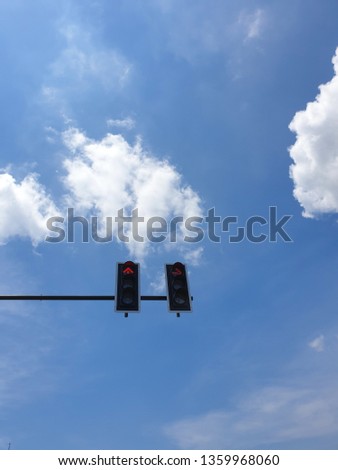 red traffic with blue sky and white cloud