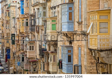A multitude of colourful wooden balconies in one of the streets of Valletta