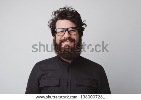 Portrait of happy and handsome bearded man looking at the camera Royalty-Free Stock Photo #1360007261
