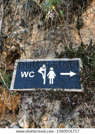 funny public toilet sign on a wall