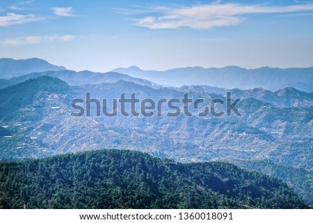 Outer Himalayas. Mountain landscapes of spring time with peaks and ridges in the blue distance
