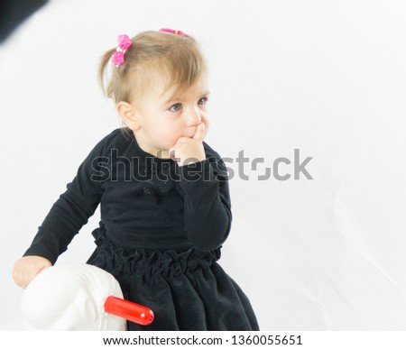 little girl child riding on toy horse