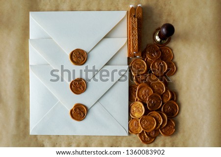 Wedding invitation in retro style, vintage. Pearl paper envelopes with gold wax seal - wedding rings silhouette