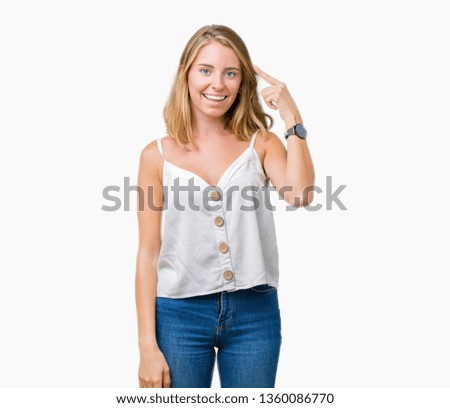 Beautiful young woman over isolated background Smiling pointing to head with one finger, great idea or thought, good memory
