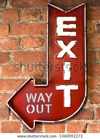 Close up of Vintage red sign Exit/Way Out, retro style on the brick wall of the building. 